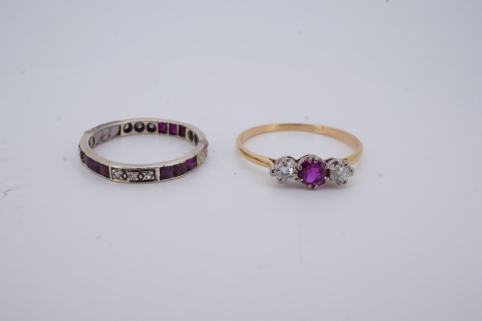 A yellow metal, stamped 18ct, ruby and diamond set three stone ring, size W, together with a yellow metal ruby and diamond set full eternity ring, size Q, gross weight 4.4 grams. Condition - poor to fair
